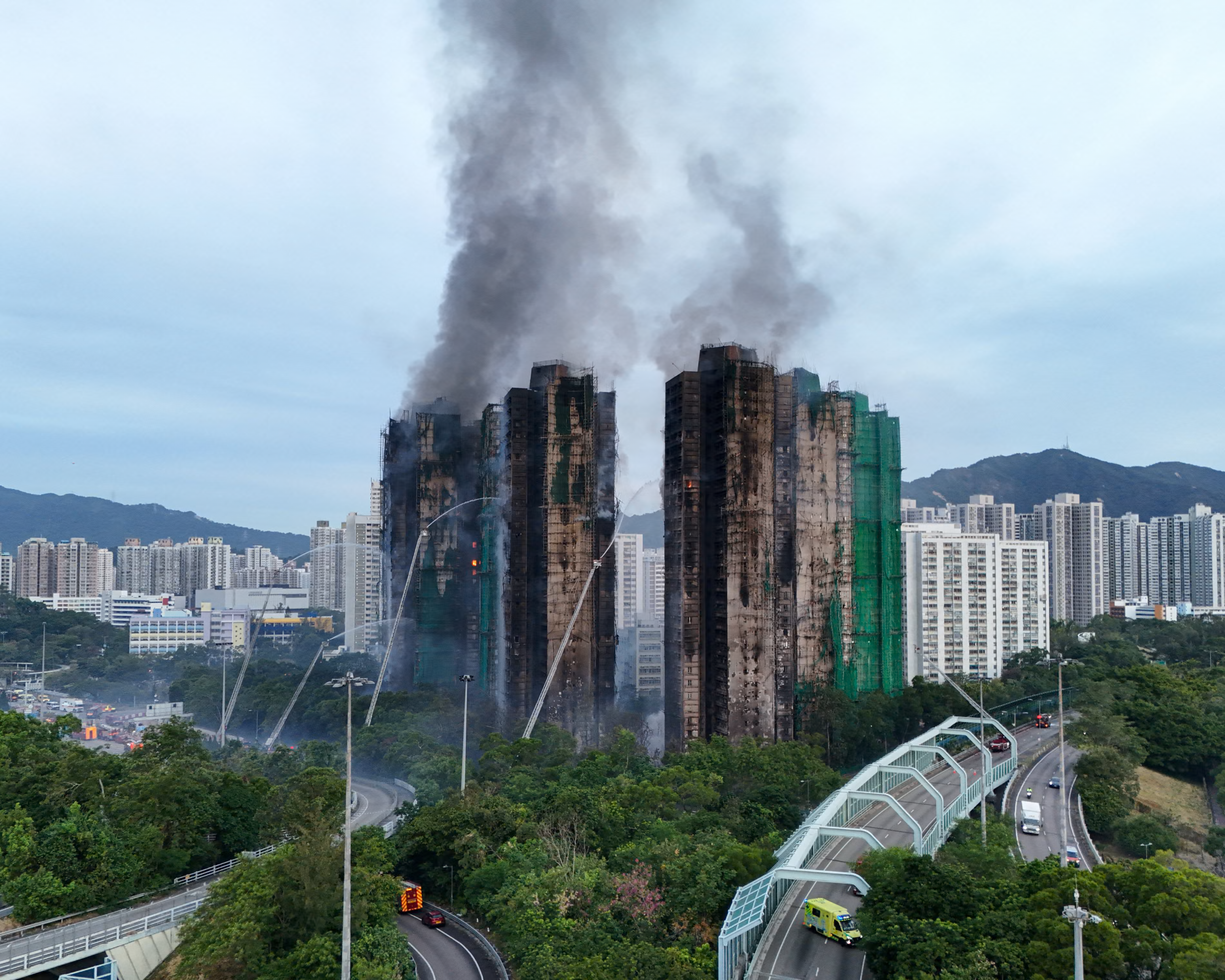 Multiple charred high-rise residence towers at Wang Fuk Court, Hong Kong.
 Photograph: Tyrone Siu/Reuters